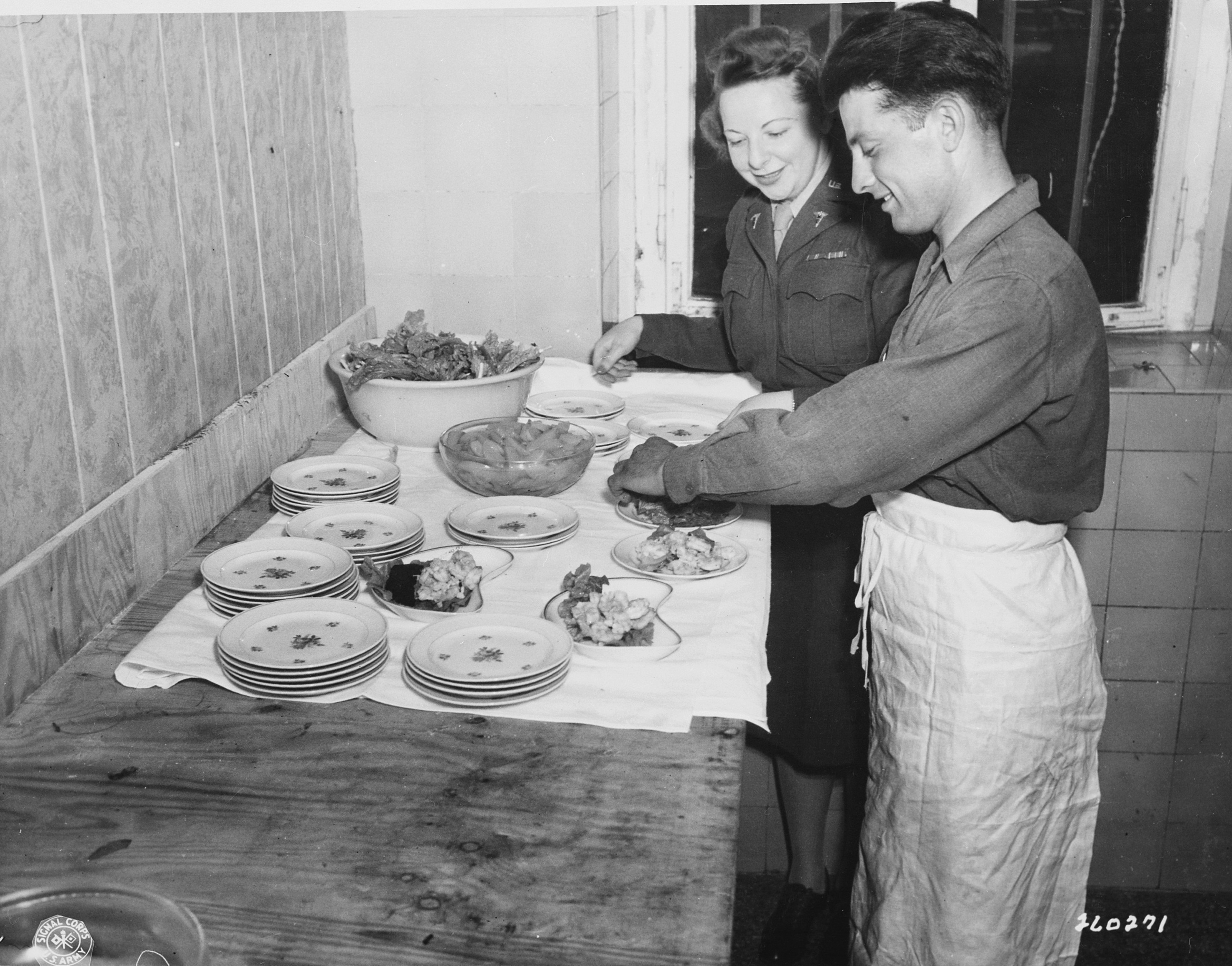 Lieutenant May Felts, chief dietician to the American delegation to the Potsdam Conference, inspecting the food being prepared, Germany, 16 Jul 1945