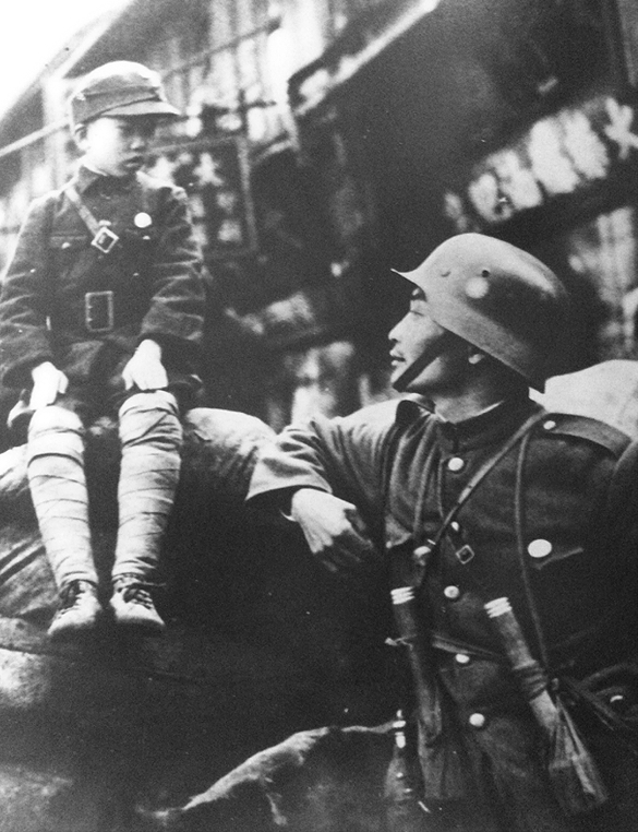 Chinese soldier with a military uniform-clad boy in Shanghai, China prior to the Japanese invasion, Jul-Aug 1937