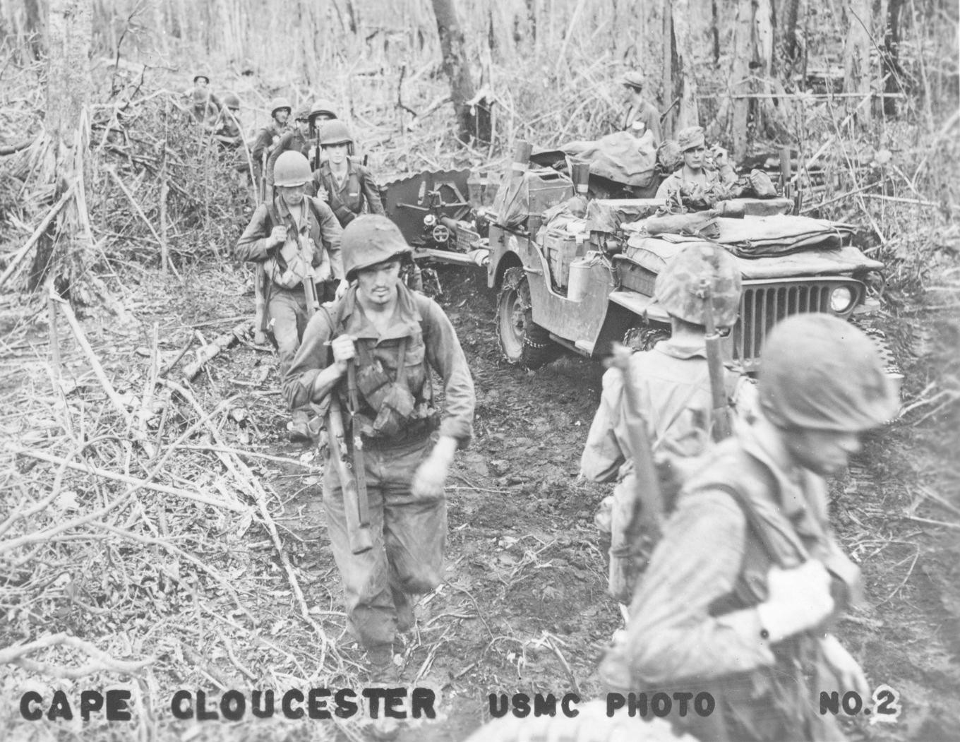 Men of the US First Marines Division at Cape Gloucester, New Britain, Bismarck Archipelago, circa late Dec 1943; note jeep being used to haul supplies