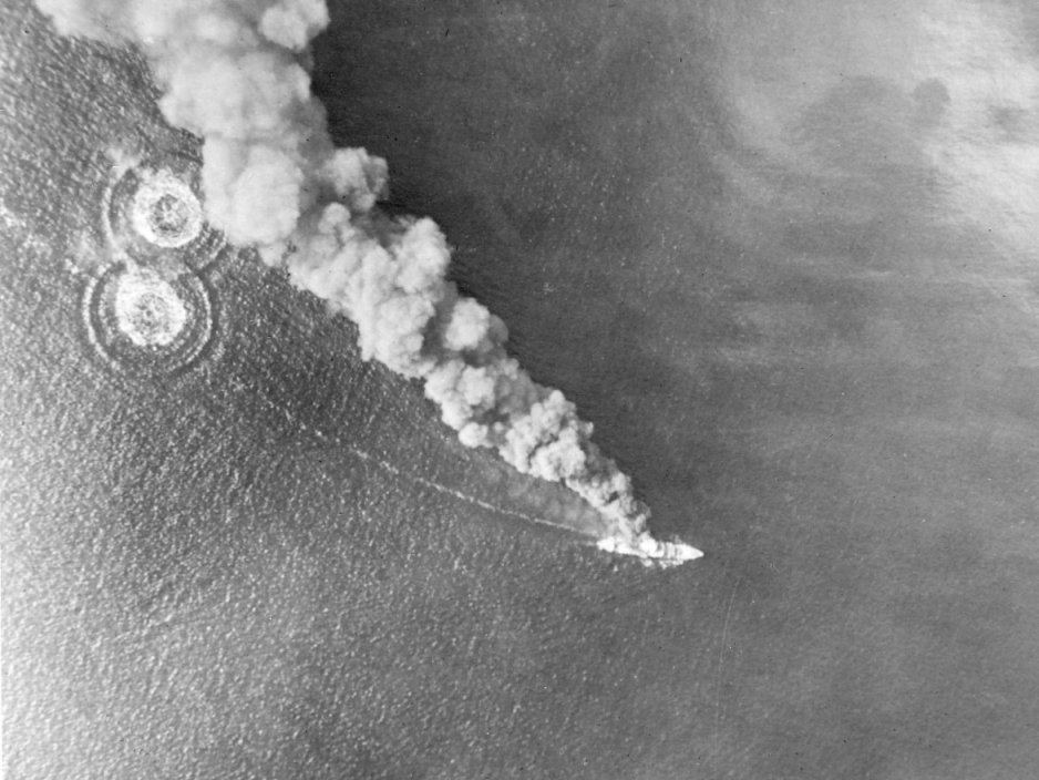 High level bombing of a Japanese ship as viewed from a B-25 bomber of 13th Bomb Squadron, USAAF 3rd Bomb Group during the Battle of Bismarck Sea, 2-4 Mar 1943