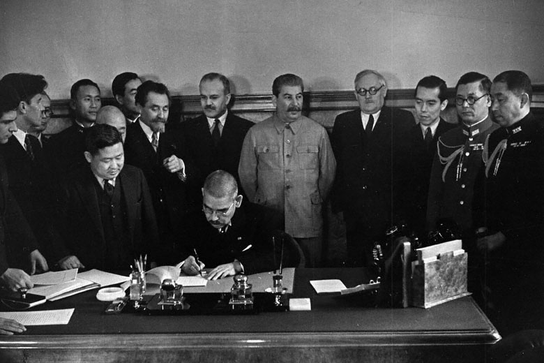 Japanese Foreign Minister Matsuoka signing the Soviet-Japanese Neutrality Pact, 13 Apr 1941, photo 1 of 3; note Molotov and Stalin in background