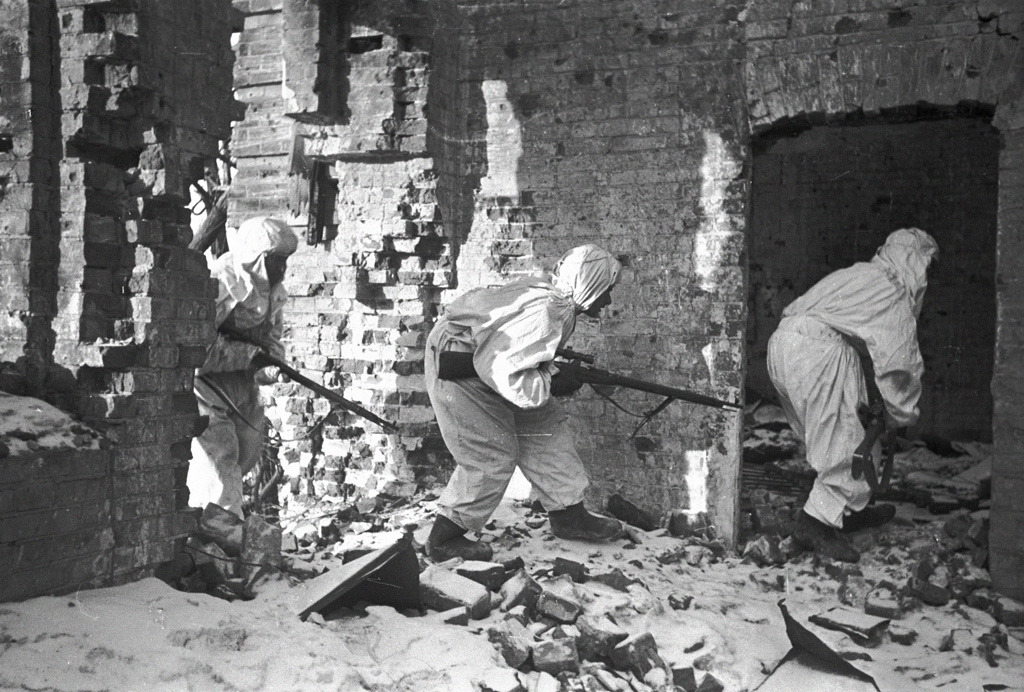 Soviet snipers moving amongst ruined buildings in Stalingrad, Russia, 1 Dec 1942