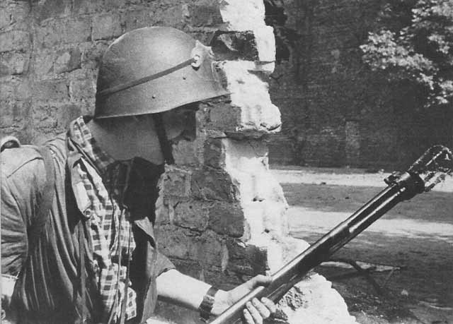 Polish resistance fighter with K pattern flamethrower and wz.31 helmet, Warsaw, Poland, 22 Aug 1944