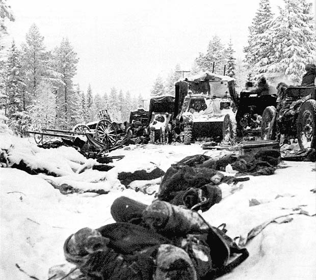 Column of Russian vehicles driving by dead Russian soldiers, Battle of Raate Road, Jan 1940