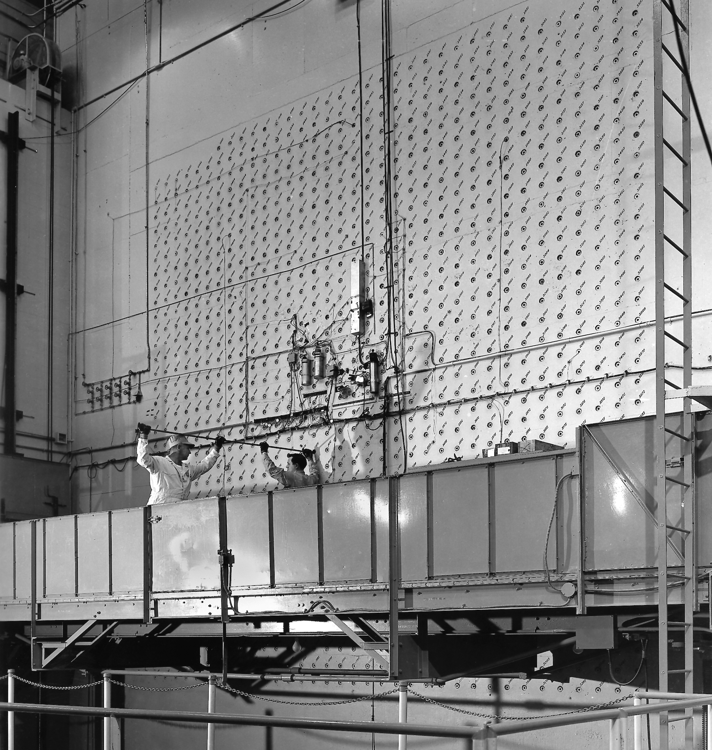Workers loading uranium slugs into the X-10 Graphite Reactor's concrete face, Oak Ridge, Tennessee, United States, circa 1943