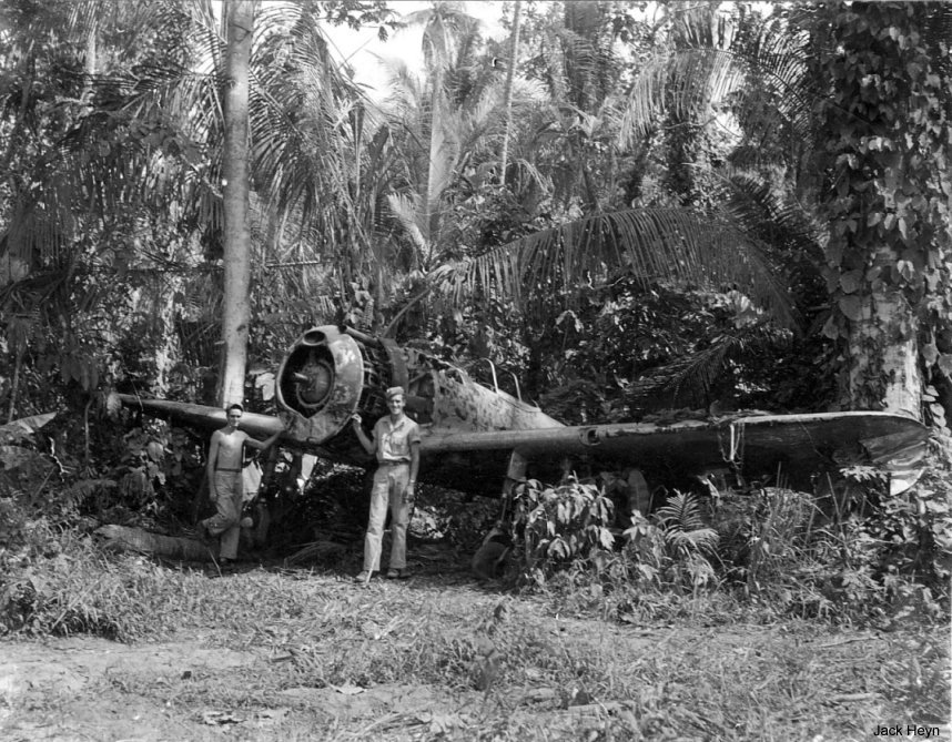 USAAF 3rd Bomb Group photographer George Tackaberry and another man with a wrecked Japanese Ki-43 fighter, Nadzab Airfield, Australian New Guinea, early 1944