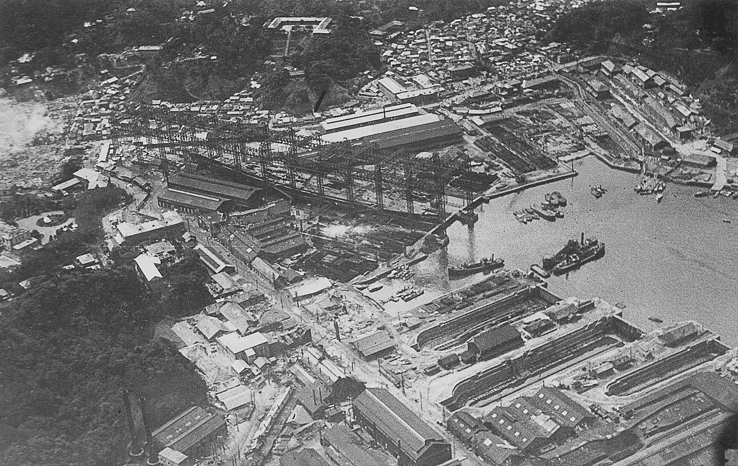 Aerial view of Yokosuka Naval Arsenal several days after the Great Kanto Earthquake of 1923, 3 or 4 Sep 1923; note battlecruiser Amagi in drydock