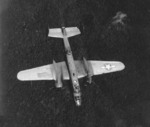 PBJ-1 Mitchell bomber of Marine Squadron VMB-413 is hit in the port engine by anti-aircraft fire over Tobera, New Britain 5 May 1944. The aircraft crashed a short time later killing all 6 of the crew.