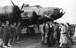 King George VI of Great Britain visits the base of the USAAF 352nd Bomb Squadron at Chelveston, England, UK, 13 Nov 1942. The aircraft is B-17F “Holey Joe” with Cpl David C Casteel of Illinois standing second from the left
