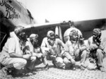 Pilots of the “Tuskegee Airmen,” 332nd Fighter Group in front of P-51C “Skipper’s Darlin’ III” flown by Capt Andrew Turner (2nd from right), at Ramitelli, Italy, 1 Aug 1944. Photo 1 of 2.