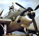Grumman TBF-1 Avenger being tended to by carrier-based maintenance personnel, 1943.