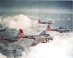B-17G Fortresses of the 381st Bomb Group are escorted by a P-51B of the 354th Fighter Squadron, Summer-Fall 1944. Photo 1 of 2.