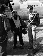 LCol Jimmy Stewart, 2nd Bomb Wing Executive Officer, speaks with Maj John Dowswell in front of Dowswell’s B-24J Liberator “Betty” at RAF Hethel, Norfolk, England, Sept 1944. Dowswell had just piloted his crippled aircraft back to England from Germany.