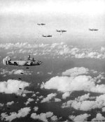B-24J Liberator “Vera L” and other aircraft from the 27th Bomb Squadron drop 55-gallon drums filled with gasoline on Iwo Jima to burn off the plant growth in advance of the landings to come two weeks later, Feb 1 1945.