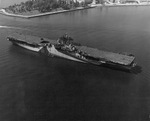 Newly commissioned USS Ticonderoga moves down the Elizabeth River from the Norfolk Navy Yard to the deperming crib, Portsmouth, Virginia, United States, May 30 1944; note camouflage Measure 33 Design 10A