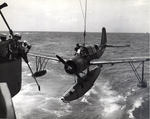 OS2U Kingfisher scout plane being recovered aboard the battleship USS Missouri, 1944-45