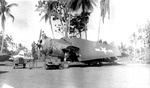A Marine Corps TBM-1C Avenger of the 7th Fleet Command undergoing some maintenance at the Cyclops aerodrome, Hollandia, New Guinea, Jul-Aug 1943. Note the Jeep and the tail of an Army A-24 Banshee painted as a target tug.