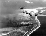 TBM-1C Avengers over Makin Island (now Butaritari Island), in the Gilbert Islands following a bombing raid, Nov 1943.