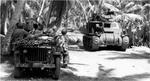 M3 Lee Medium Tank, with a 75mm gun in the sponson and a 37mm gun in the turret, on Butaritari Island, Makin Atoll, Gilbert Islands, Nov 1943. A medical crew waits beside their jeep for tanks to pass.