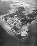 Aerial view of Peleliu in Oct 1946.  Many facilities have been built and the jungle growth has returned to the coral island since the fierce fighting of 1944 stripped it bare.  Even so, the contours of the Umurbrogol Mountains can easily be seen.