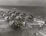 One SNJ Texan and 13 FM-2 Wildcats tied down on the flight deck of training aircraft carrier USS Sable on Lake Michigan, United States, 1944.