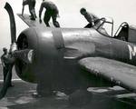 Crews move to secure an FM-2 Wildcat after a hard landing on the training aircraft carrier USS Sable on Lake Michigan, United States, 1945.