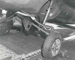 The damaged landing gear of an FM-2 Wildcat after a hard landing aboard the training aircraft carrier USS Sable on Lake Michigan, United States, 1943-45.