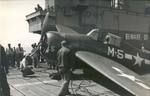 Deck crews secure a damaged FM-2 Wildcat following a hard landing aboard the training aircraft carrier USS Sable on Lake Michigan, United States, 1943-44.