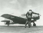 The Deck Officer gives an SNJ-3C Texan the go-ahead to launch from the training aircraft carrier USS Wolverine on Lake Michigan, United States, 26 Apr 1943.