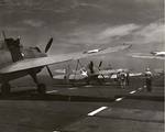 An SNJ Texan, an F4F Wildcat, and a TBF-1 Avenger tied down on the flight deck of the training aircraft carrier USS Wolverine on Lake Michigan, United States, 1943.