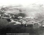 Aerial photo of the seaplane hangars and ramps at Luke Field on Ford Island in Pearl Harbor, Hawaii, early 1920s.  Note the empty island center and opposite shore.