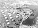 The Submarine Base at Pearl Harbor, Hawaii, with Merry Point beyond, Oct 1941. The large building in the center is Pacific Fleet Headquarters. Note the camouflage schemes painted on some of the fuel storage tanks.