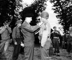 General Bernard Montgomery pins the British Military Medal on the uniform on T/Sgt Philip Streczyk of the US First Division for extraordinary gallantry on Omaha Beach, Normandy, France, on D-Day.  Award presented Jul 7 1944.