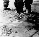 Oil storage tanks south of Saigon (Ho Chi Minh City), French Indochina (Vietnam) burn after being bombed by United States Navy carrier planes, Jan 12, 1945