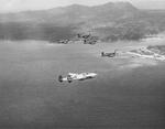 USAAF Photo Reconnaissance F-5E Lightning ‘Information Please’ accompanying Marine F4U Corsairs on a raid to Kushi-Take, Okinawa, Japan, June 1945. Photo 1 of 2. Note the photo nacelle under the F-5.