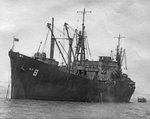 Attack Cargo Ship USS Algorab at anchor circa 1943, location unknown. Note LCVP coming alongside.