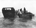 US Marines practice transferring troops from LCVP landing craft to LVT Water Buffalo in the Solomons preparing for the landings on Guam, Marianas, mid-1944.