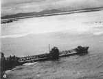 Large Type 2TL tanker Kyokuun Maru on fire and making for the beach off the coast of French Indochina (Vietnam) north of Qui Nhon after its convoy was attacked by 175 United States Navy carrier planes, Jan 12, 1945.