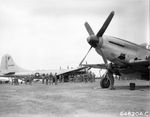 Marines on Iwo Jima crowd around a newly arrived Boeing F-13 Superfortress (photo reconnaissance variant of the B-29). 47th Fighter Squadron P-51D Mustang is in foreground, Mar-Apr 1945.