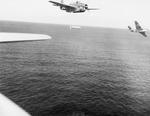 A training flight of TBF-1 Avengers lining up to drop practice torpedoes, late 1942, off the east coast of the United States. Photo 2 of 4.