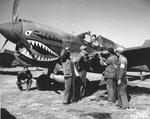 Chinese and American armorers checking the guns on a Curtiss P-40E Warhawk of the 74th Fighter Squadron, 23rd Fighter Group at Kunming, China, 1 Feb 1943