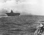 USS Yorktown (Essex-class) steaming in reverse and landing an F6F-3 over the bow during trials, probably in the Gulf of Paria, Jul 1943