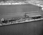 USS Yorktown (Essex-class) at the Alameda Naval Air Station loading aircraft and vehicles for transportation to the Pacific, 14 Sep 1943. Note three PV-1 Venturas on the after flight deck. Photo 1 of 2.