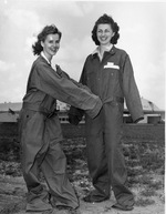 WASP cadets Leonora Anderson and Mildred Axton show off the oversized and ill-fitting jump suits provided to the WASP program, Avenger Field, Sweetwater, Texas, United States, May 1943.