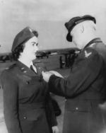 WASP pilot Barbara Erickson being awarded the Air Medal from the Army Air Forces Commanding General, Henry “Hap” Arnold, during the graduation ceremony for WASP cadet class 44-W-2, Avenger Field, Texas, 11 Mar 1944