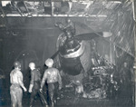 Damage control parties trying to bring fires under control on the hangar deck of USS Intrepid following the crash of a Japanese special attack aircraft off the Philippines, 25 Nov 1944