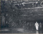Damage control parties trying to bring fires under control on the hangar deck of USS Intrepid following the crash of a Japanese special attack aircraft off the Philippines, 25 Nov 1944
