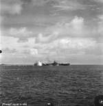 Carrier USS Bunker Hill taking a near miss from a Japanese dive bomber close aboard the starboard quarter, 19 Jun 1944 off Guam, Mariana Islands. The ship was not damaged. Photo 1 of 2