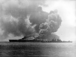 The USS Bunker Hill, burning from two special attack aircraft crashing through the flight deck off Okinawa, is assisted by cruiser Pasadena, 11 May 1945.