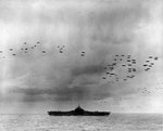 The US Third Fleet steaming in tight formation for a photo opportunity as close to 200 airplanes fly overhead, 22 Aug 1945. Photo taken from USS Wasp (Essex-class). Carrier seen is almost certainly the USS Randolph.